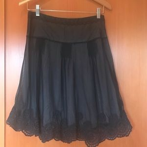 Skirt with embroidered overlay.